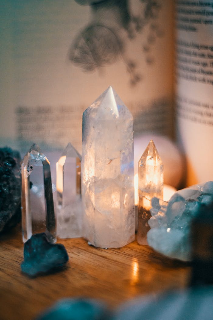 About Beautiful quartz crystals displayed on a wooden table with warm ambient lighting.