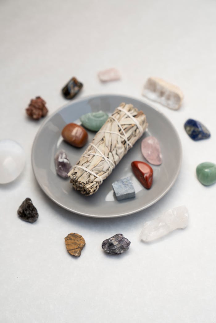 services-02 Flat lay of sage bundle and healing crystals for spiritual rituals on a plate, ideal for mindfulness and energy cleansing.